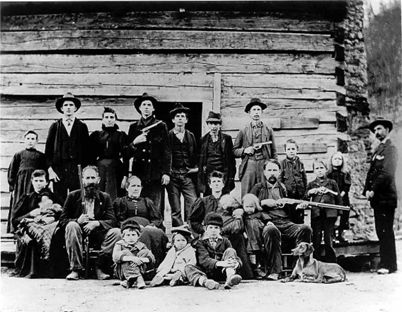 An old photo of a family with guns